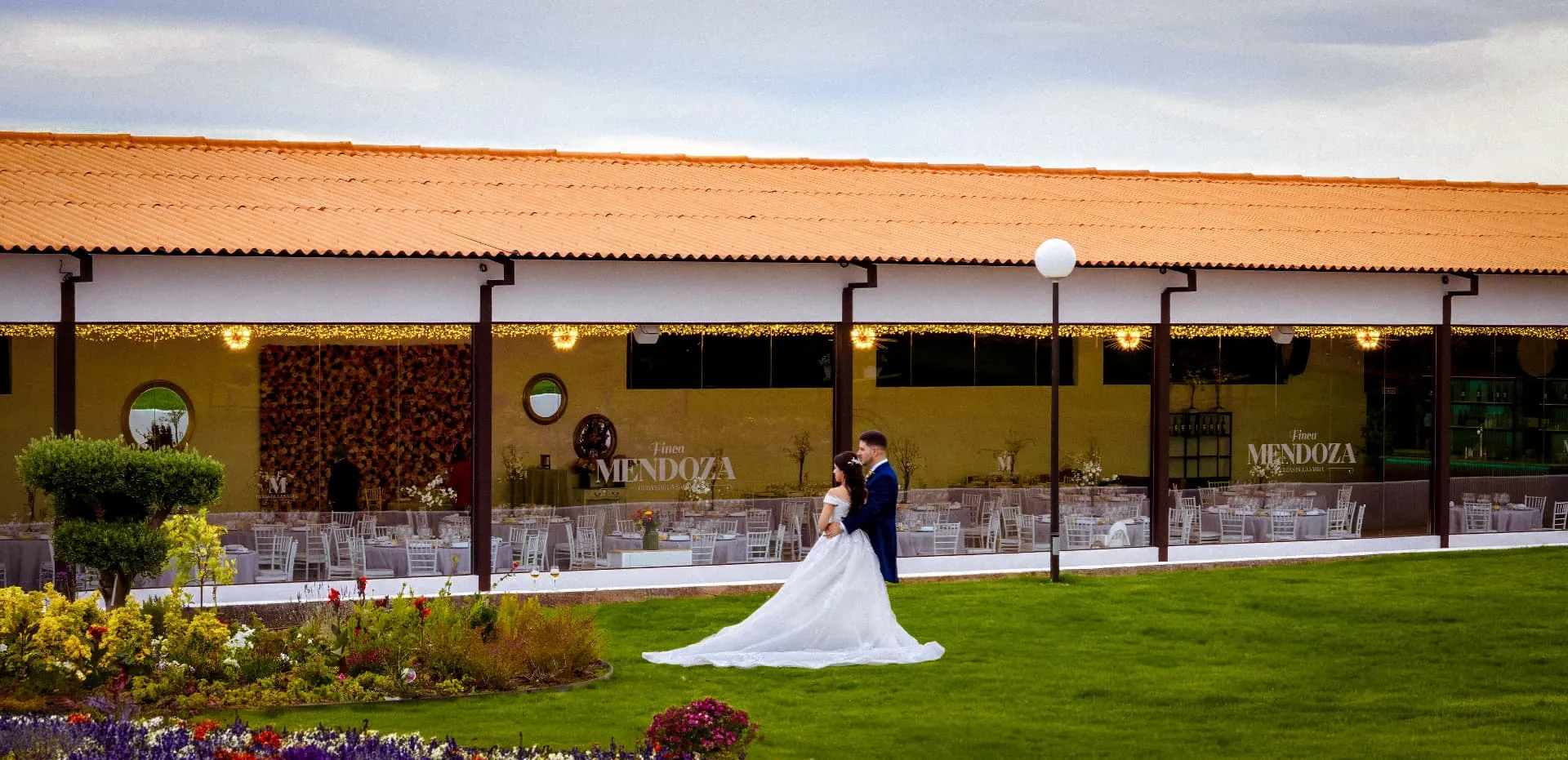 Salón acristalado de Finca Mendoza con novios en el jardín
